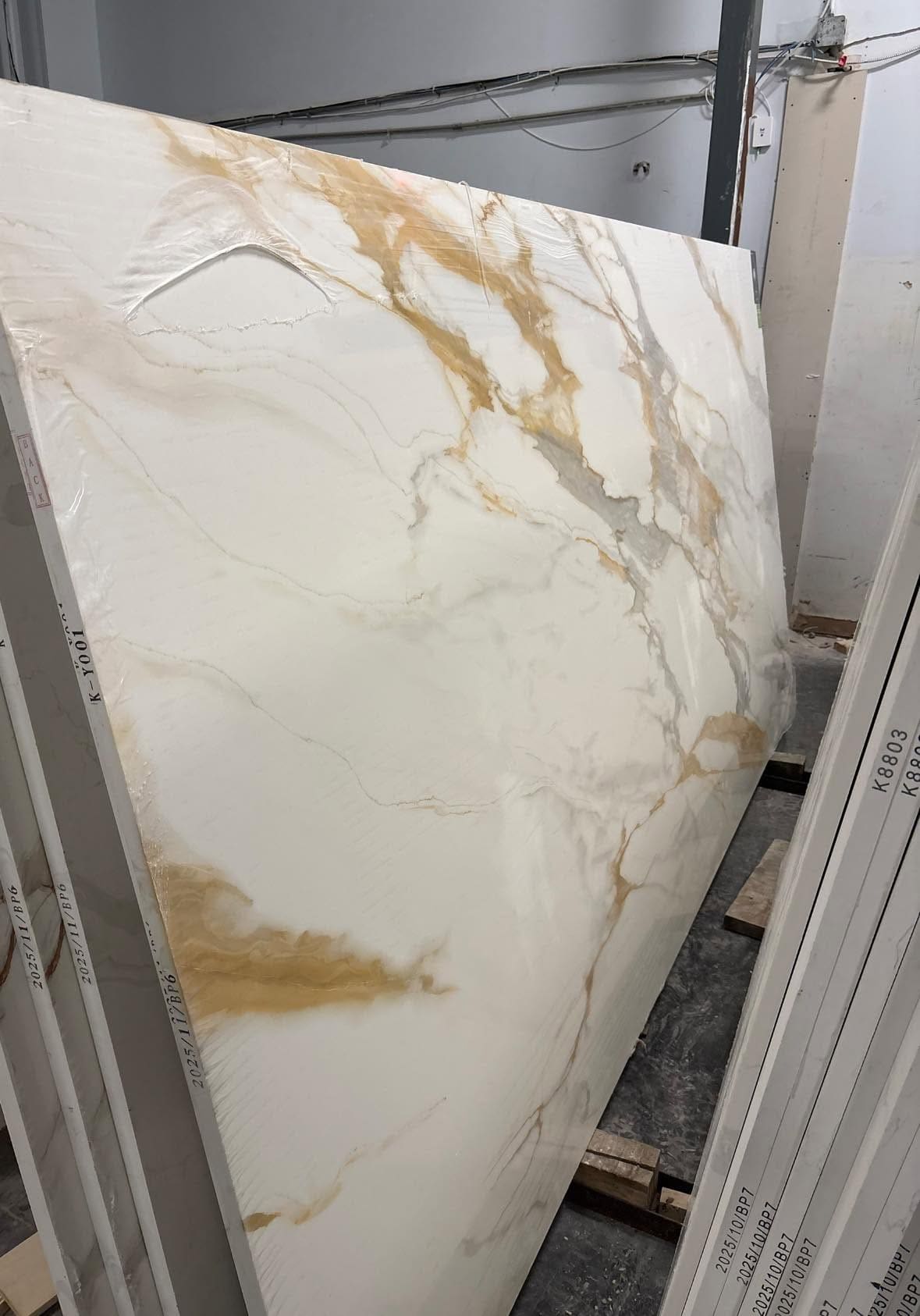 Full marble slab with gold and grey veining standing in the yard