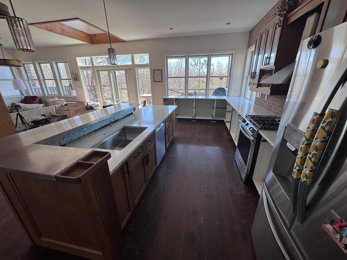 Stone countertop run against dark cabinetry with an island
