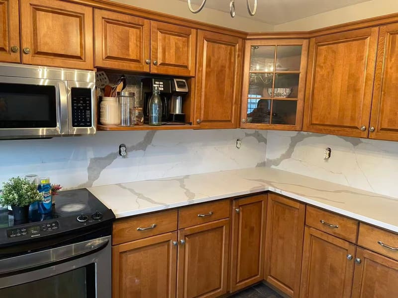 Marble-look quartz counters against maple cabinetry