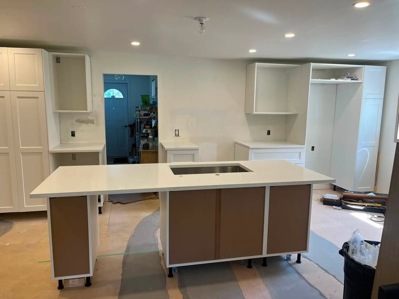 Walnut cabinetry paired with a white quartz island top